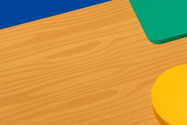 Close-up of a laminate kitchen worktop with a subtle wood grain pattern.